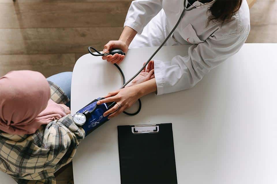 Photo Of Doctor Taking Patients Blood Pressure