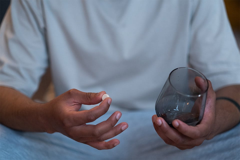 Photo Of A Man Holding A Pill