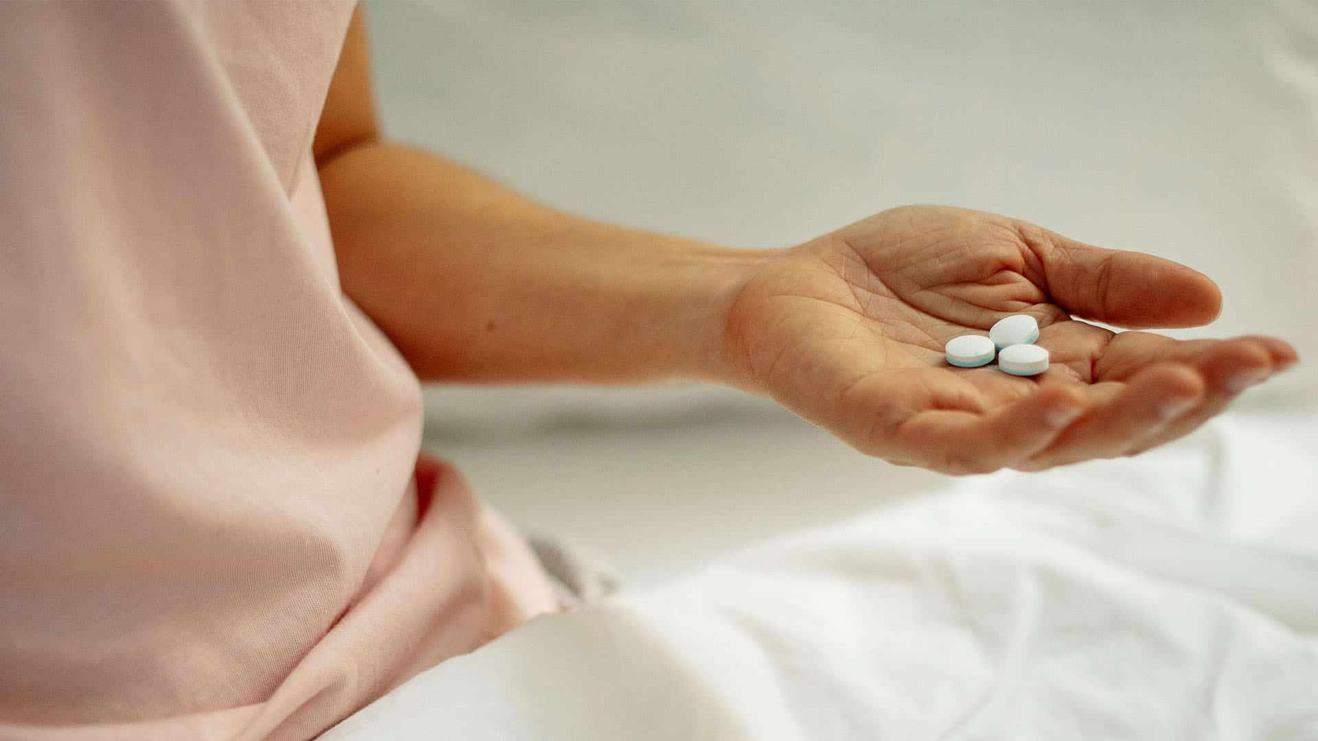 woman preparing for taking painkiller in hand