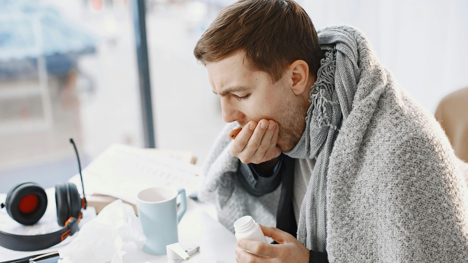 A Sick Man Covering His Mouth