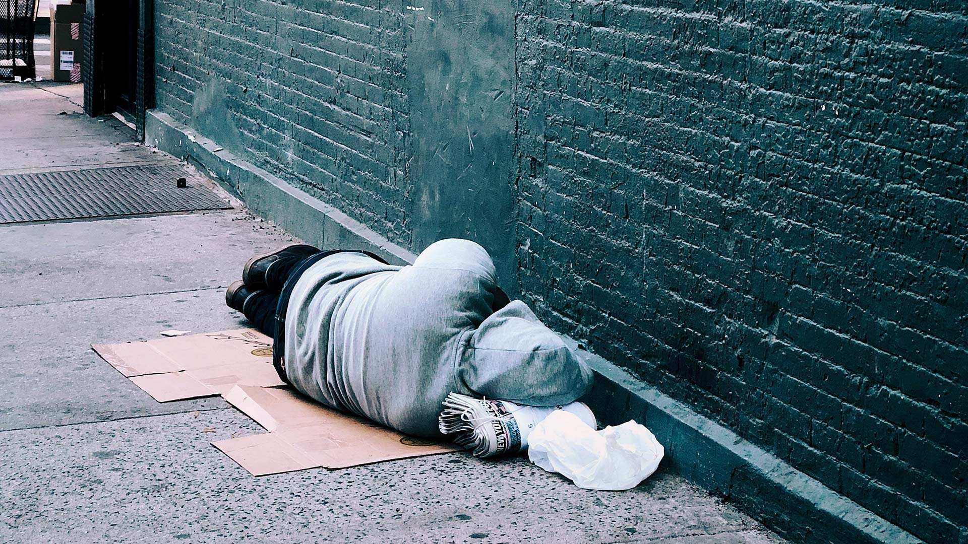 man lying on brown cardboard box