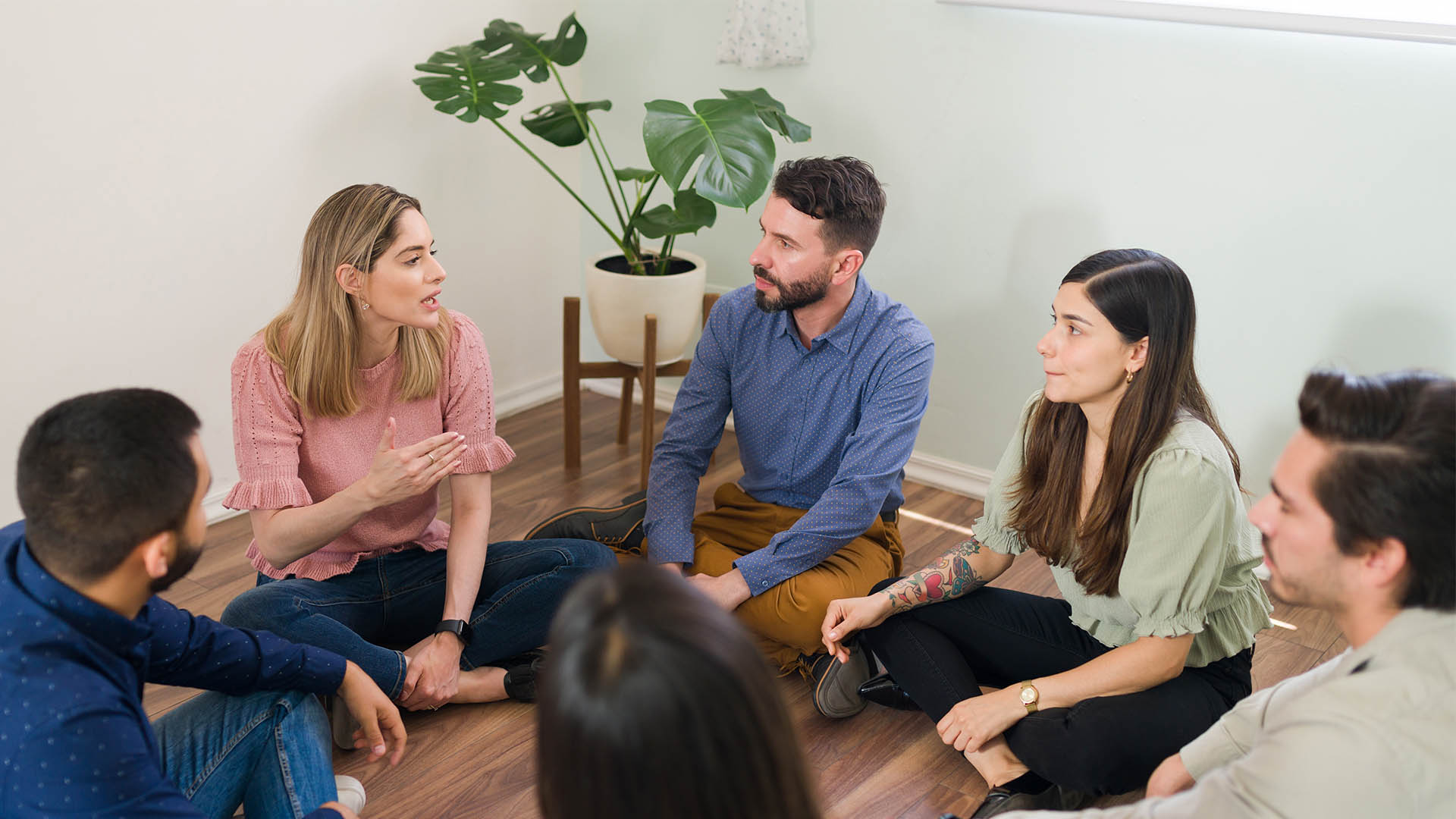 woman sharing her experience with addiction with her rehab group