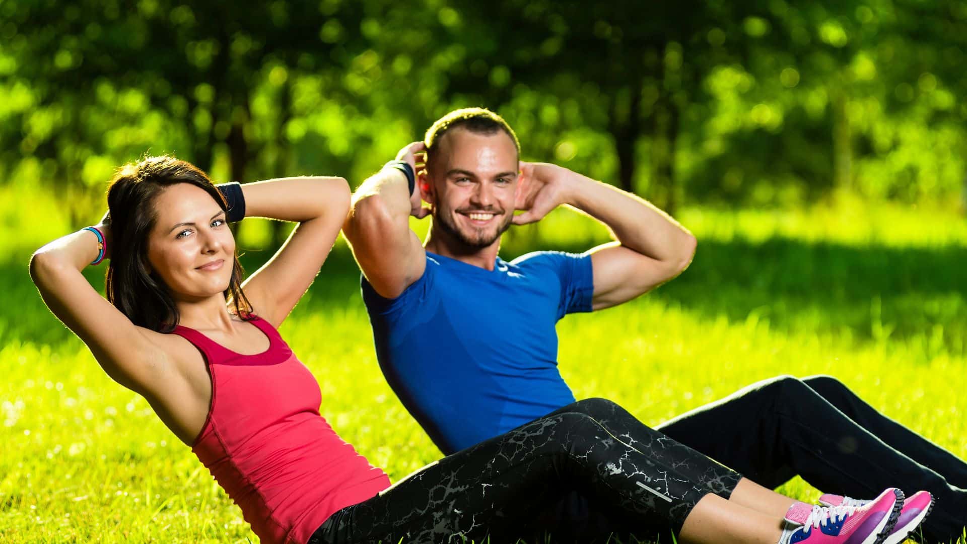 couple exercising in park