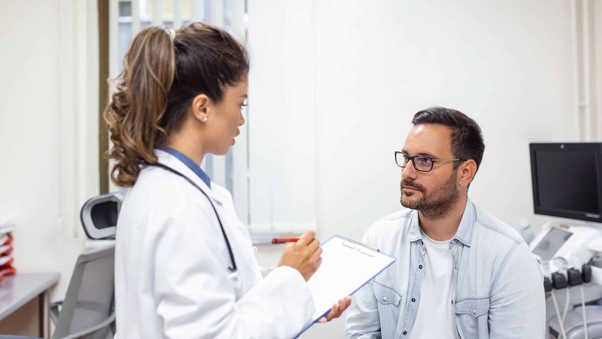 man consulting young female physician doctor