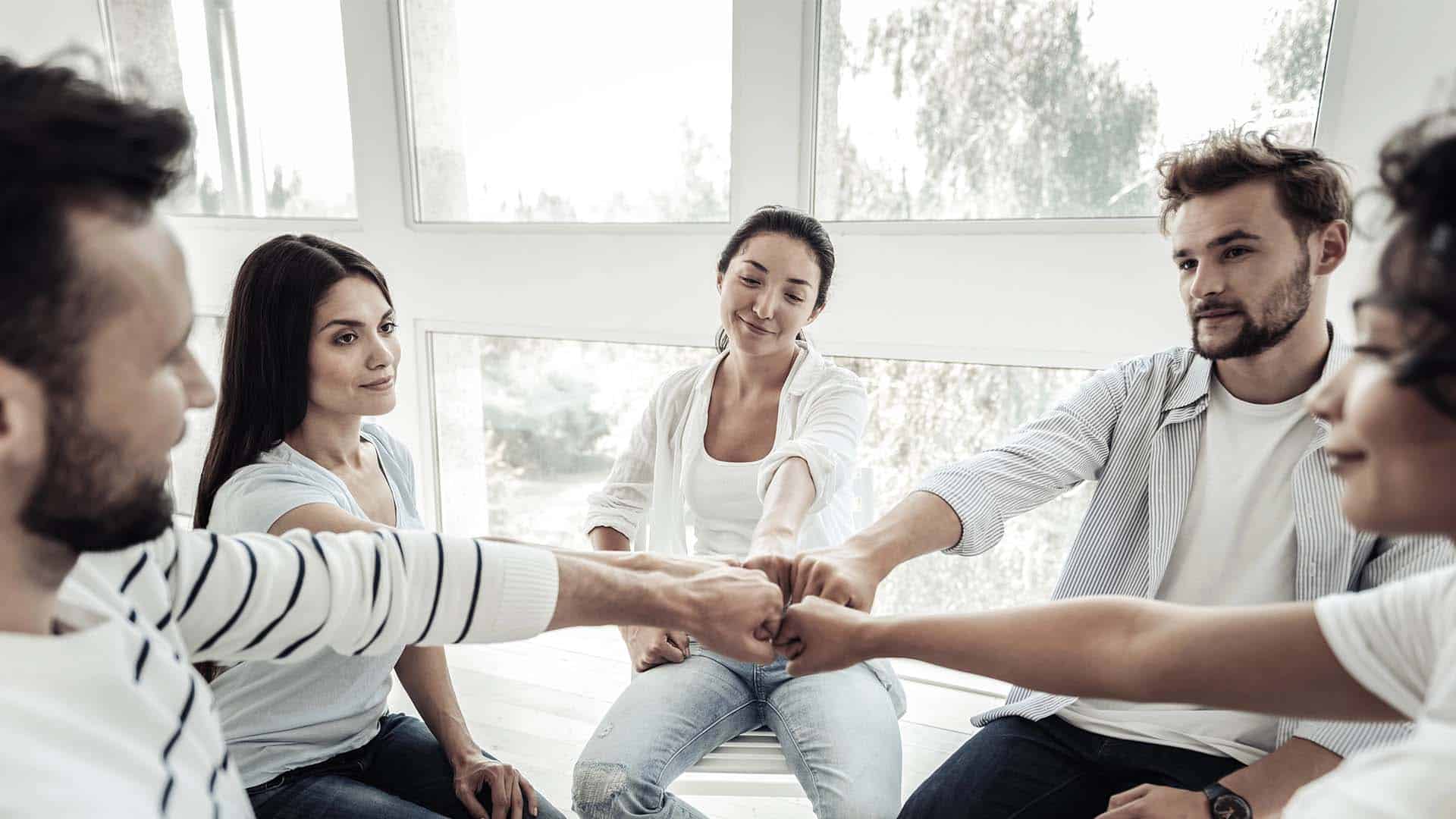 positive young people sitting in the circle